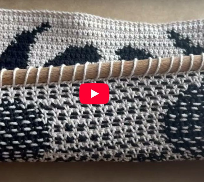 Load video: adding a dowel to crochet tapestry